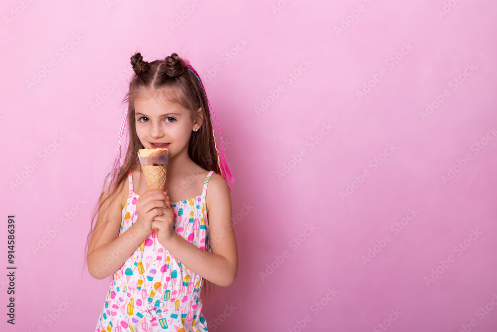 Happy little girl eating ice cream in a cone on a pink background. So yummy. Closeup photo of beautiful funny little lady. A child holds ice cream in his hand in a cup on a pink background. Happy little girl eating ice cream in a cone on a pink background. So yummy. Closeup photo of beautiful funny little lady. A child holds ice cream in his hand in a cup on a pink background.