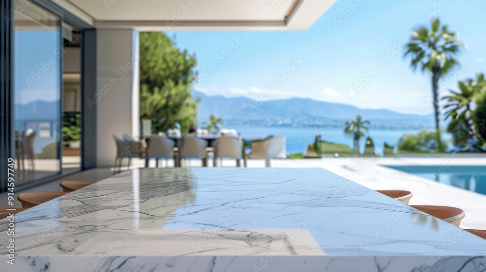 Obraz premium Marble table in elegant villa with blurred pool backdrop