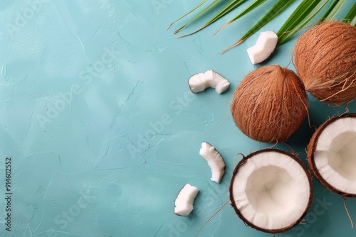 Whole and Halved Coconuts on Blue Background