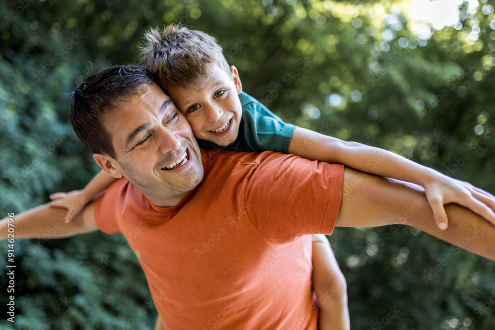 Father playing with his son piggy back. Father playing with his son piggy back.