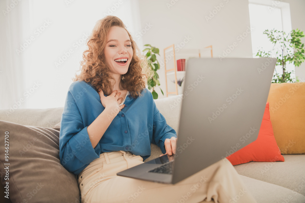 Photo of cheerful young female sit sofa netbook video call talk blue shirt enjoy weekend buy new apartment indoors inside house home Photo of cheerful young female sit sofa netbook video call talk blue shirt enjoy weekend buy new apartment indoors inside house home