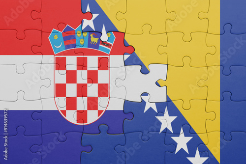 puzzle with the colourful national flag of bosnia and herzegovina and flag of croatia. photo