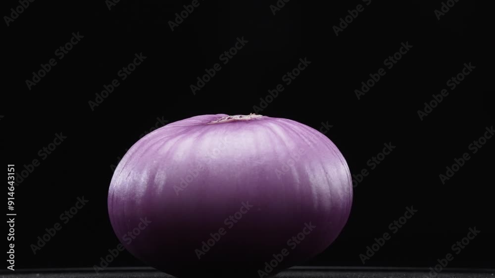 Macrography of peeled red onion against a sleek black background takes center stage. Each close-up shot meticulously captures the intricate details and textures of the onion. Close up. Comestible.