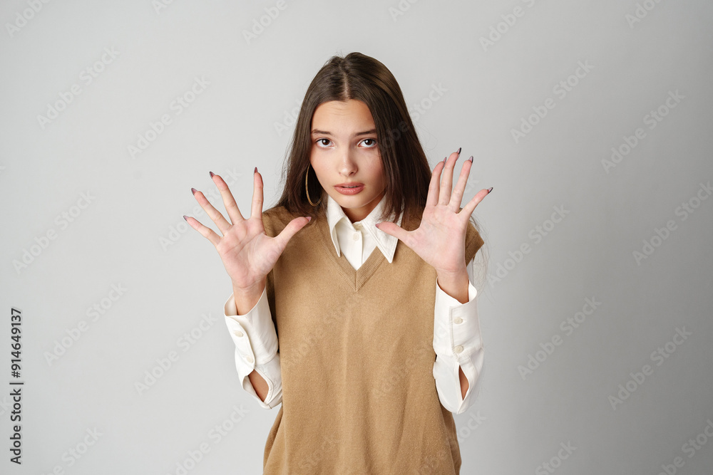 Young Woman Posing With Hand Raised Sign Young Woman Posing With Hand Raised Sign