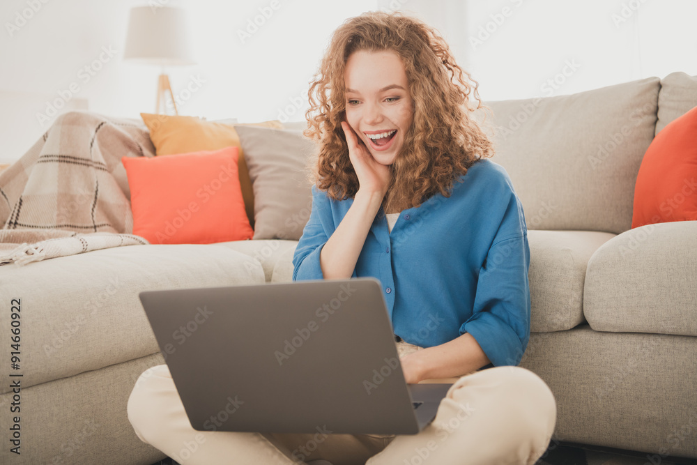 Photo of cheerful young female sit floor netbook amazed reaction blue shirt enjoy weekend buy new apartment indoors inside house home Photo of cheerful young female sit floor netbook amazed reaction blue shirt enjoy weekend buy new apartment indoors inside house home