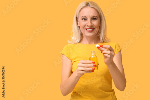 Mature woman taking fish oi...