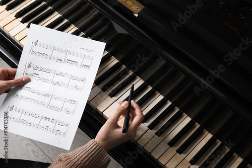 Young woman composing music with piano