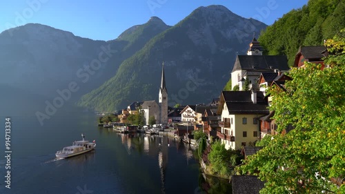 Hallstatt Village Ferry Pulling Up to Dock 4K UHD. The passenger ferry arrives at Hallstatt village on Hallstatter Lake in the Austrian Alps in the region of Salzkammergut, Austria. 4K, UHD.
