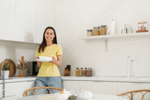 Young woman with stack of p...