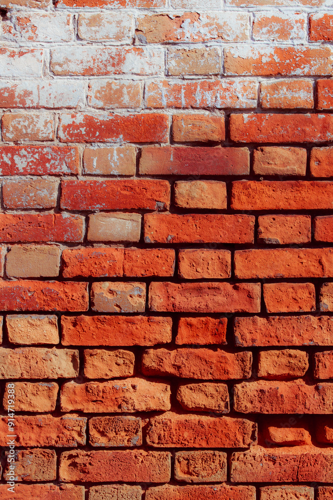 Old grungy red brick wall. Free space for an inscription. Fragment of a wall with bumps and peeling paint. Old grungy red brick wall. Free space for an inscription. Fragment of a wall with bumps and peeling paint.