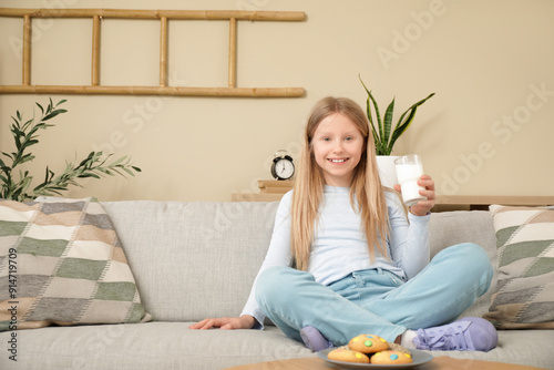 Little girl with glass of m...