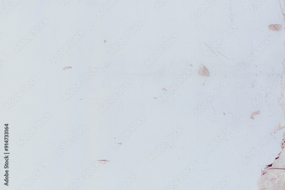 White plaster wall with natural defects. Fragment of the grunge surface. Natural cracked cement on a light wall. Textured background for integration into the design. White plaster wall with natural defects. Fragment of the grunge surface. Natural cracked cement on a light wall. Textured background for integration into the design.