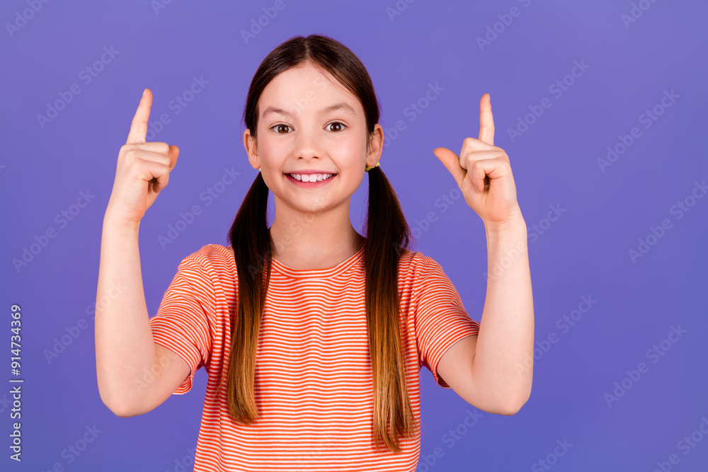 Photo portrait of pretty little girl point empty space wear trendy red outfit isolated on purple color background Photo portrait of pretty little girl point empty space wear trendy red outfit isolated on purple color background