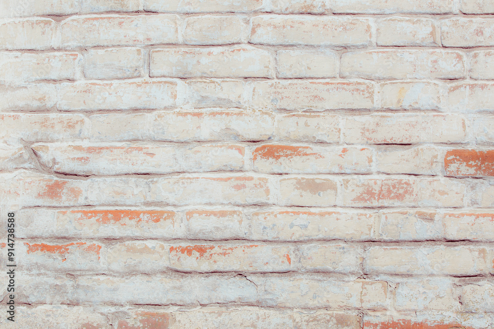 Old grungy red brick wall. Free space for an inscription. Fragment of a wall with bumps and peeling paint. Old grungy red brick wall. Free space for an inscription. Fragment of a wall with bumps and peeling paint.
