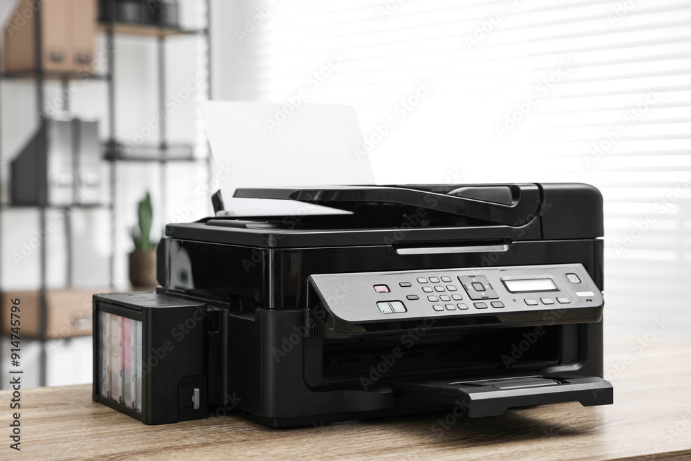 Modern printer with paper on table in office Modern printer with paper on table in office