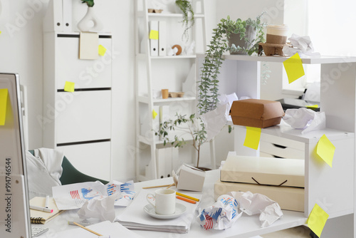 Messy office desk with crum...