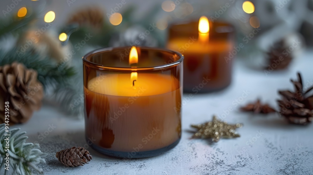 White candles in brown glass on gray surface. Cozy home decor. Christmas interiors. White candles in brown glass on gray surface. Cozy home decor. Christmas interiors.