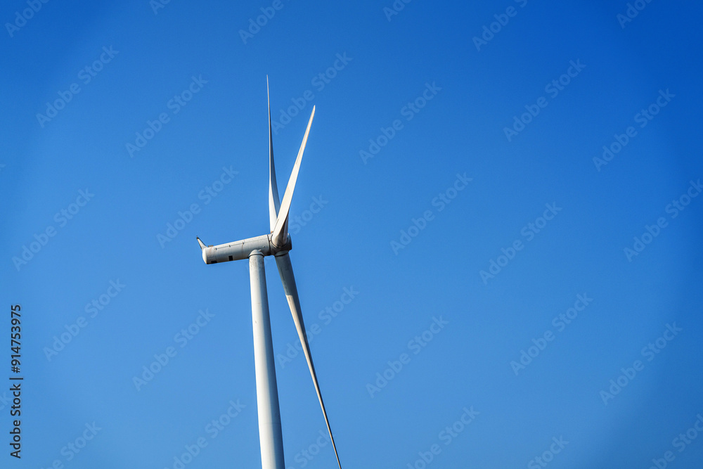 Windmills for electric power production, harnessing wind against the vast sky. Windmills for electric power production, harnessing wind against the vast sky.
