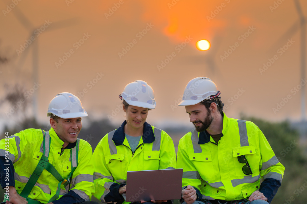 Fototapeta premium Team Engineers men and woman checking and inspecting on construction with sunset sky. people operation. Wind turbine for electrical of clean energy and environment. Industrial of sustainable.