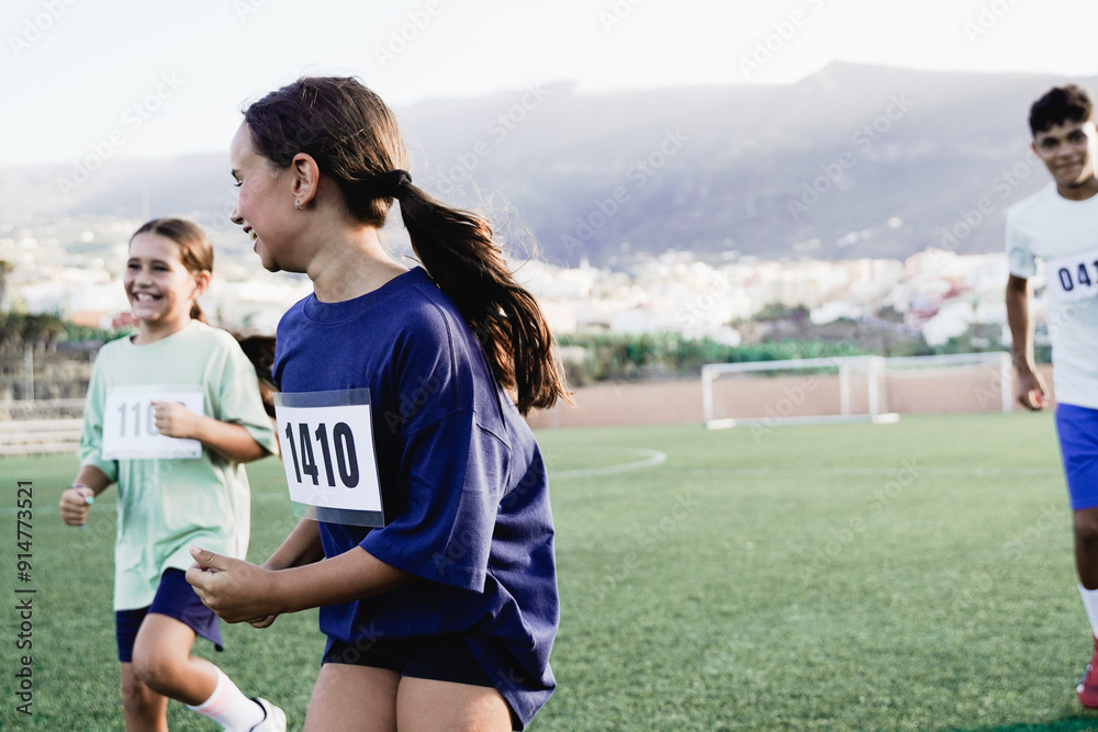 Sport children running in marathon competition at school soccer field. Kids healthy lifestyle concept Sport children running in marathon competition at school soccer field. Kids healthy lifestyle concept