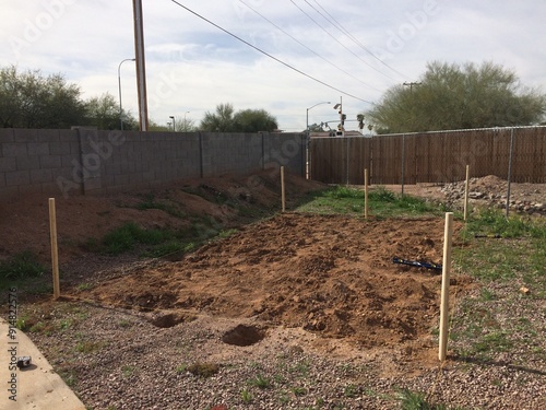 Putting up Posts for a Fence on In Ground Garden in Arizona Backyard