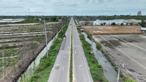 high voltage power line on rural countryside road with vehicle transporting in cloudy sky weather feel like lonely and adventure