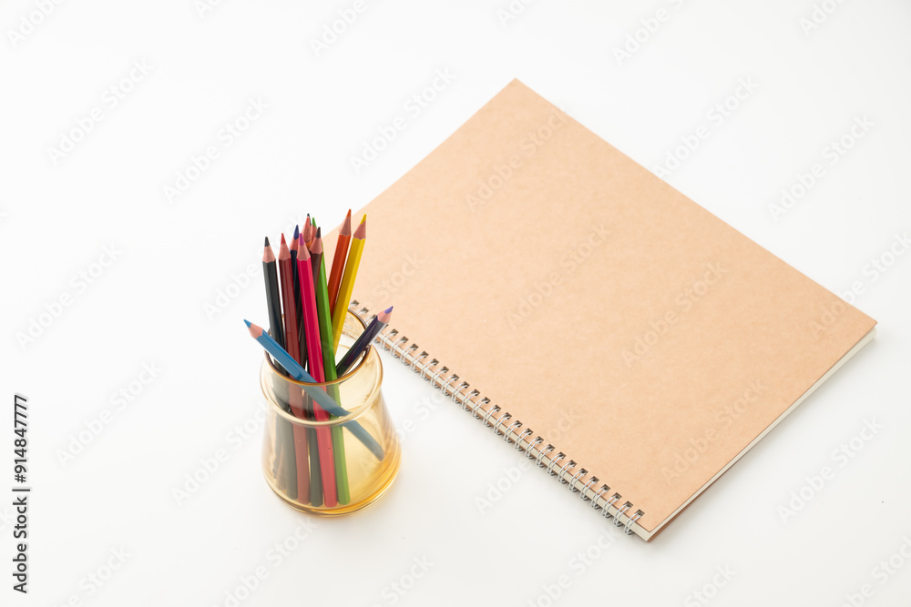 Colored pencils with notebook on white background.
School and office supplies image.
Colored pencils with notebook on white background.
School and office supplies image.