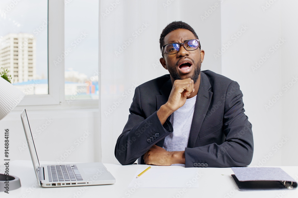Thoughtful businessman in formal attire contemplating strategy at office desk with hand on chin and glasses Thoughtful businessman in formal attire contemplating strategy at office desk with hand on chin and glasses