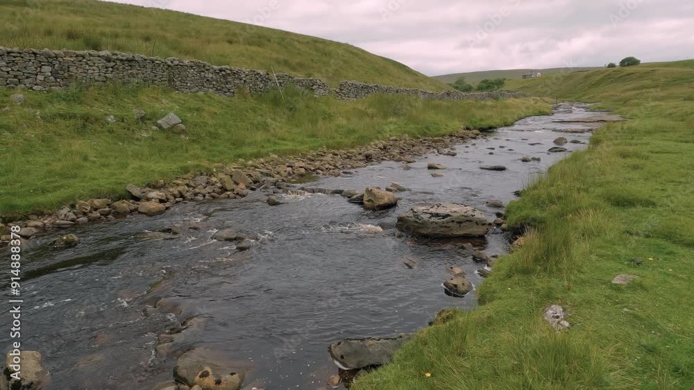 Clean river water flowing Yorkshire Whernside countryside rural landscape, UK Clean river water flowing Yorkshire Whernside countryside rural landscape, UK