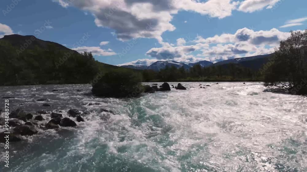Aerial view of a beautiful river with crystal clear water, surrounded by mountains and lush vegetation under a bright blue sky. Aerial view of a beautiful river with crystal clear water, surrounded by mountains and lush vegetation under a bright blue sky.