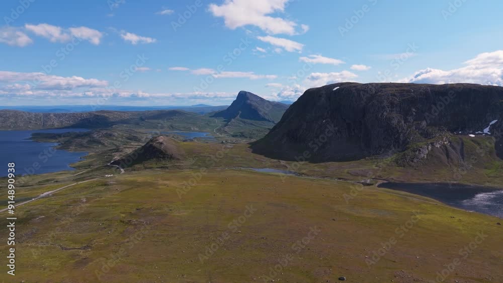 A breathtaking aerial view of a mountain range with vast open plains and a clear blue sky, capturing natural beauty and tranquility. dolly left A breathtaking aerial view of a mountain range with vast open plains and a clear blue sky, capturing natural beauty and tranquility. dolly left