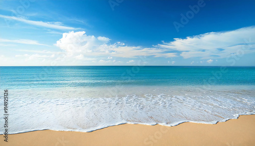 The wide sea and the sandy beach. Blue sky.