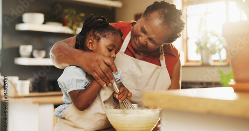 Fotografie Baking, black child and grandmother in kitchen for support, recipe process and mixing batter at home