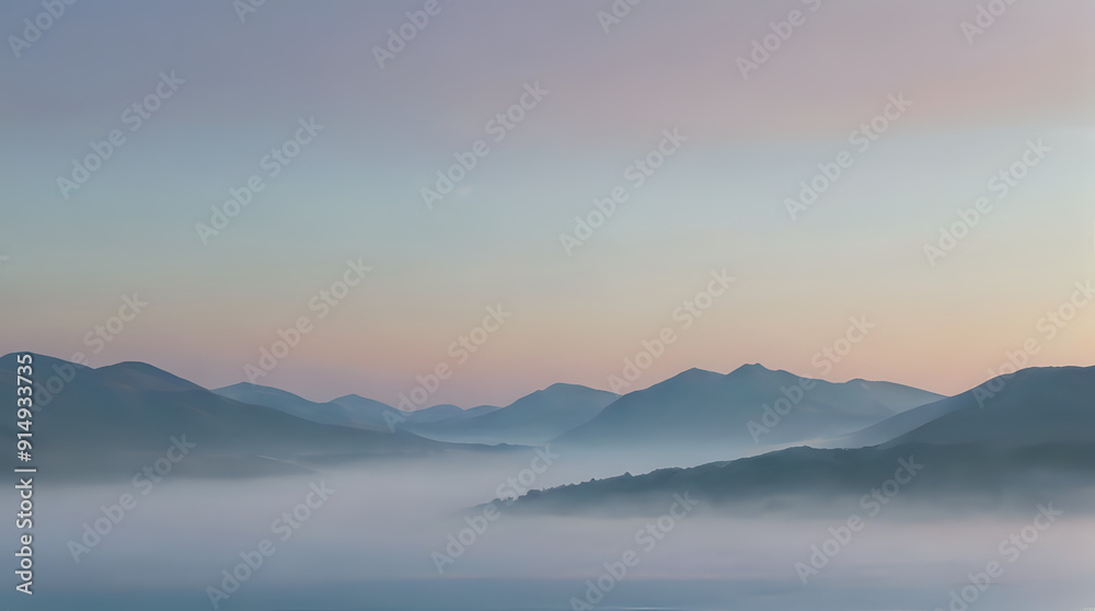 Fototapeta premium mountains covered in fog and low clouds at sunset