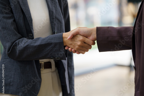 Close-up. Young casual business people are shaking hands with each other.