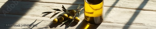 Natural Essence of Health: A Bottle of Olive Oil with Fresh Olives and Branches Casting Shadows on a Rustic Surface, Emphasizing the Product's Natural and Healthy Qualities. photo