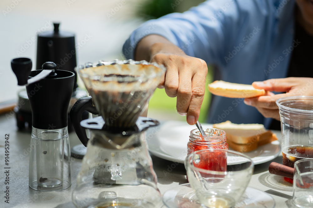 Close-up of a man drinking coffee and eating at a bakery in the park. Close-up of a man drinking coffee and eating at a bakery in the park.