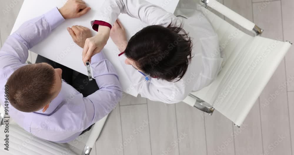 Dermatologist or ophthalmologist examines patient face or eyes using magnifying glass, top view Dermatologist or ophthalmologist examines patient face or eyes using magnifying glass, top view