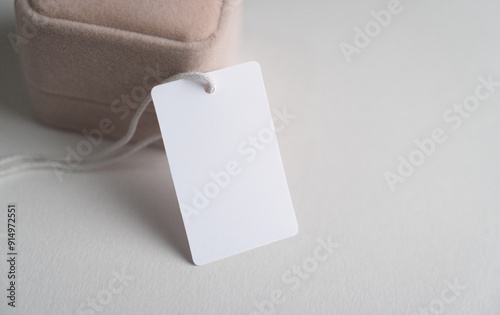 Mockup of a white price tag, placed beside a jewelry box. Mockup of a white price tag, with clipping path photo