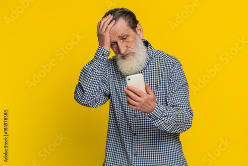 Fotografie Upset sad senior man use smartphone typing browsing, play game, loses, surprised by sudden lottery results bad fortune loss fail unlucky news