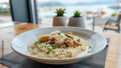 Closeup of a plate of creamy mushroom risotto with herbs and parmesan cheese. photo