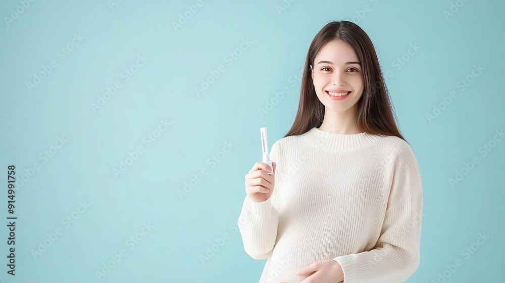 Smiling woman holding a toothbrush, promoting oral hygiene. Smiling woman holding a toothbrush, promoting oral hygiene.