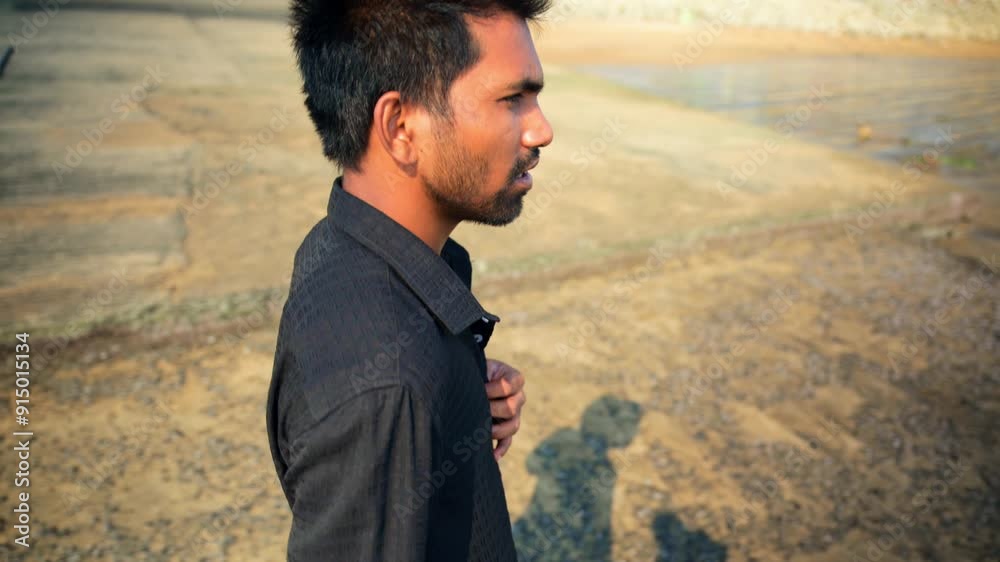 Young Man Walking by The Beach