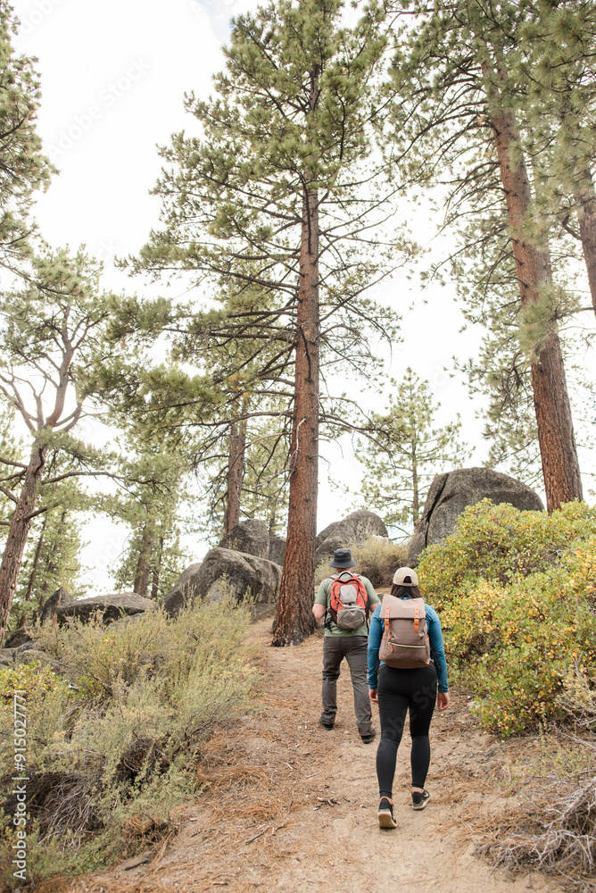 Couple walking outdoors together on a trail Couple walking outdoors together on a trail