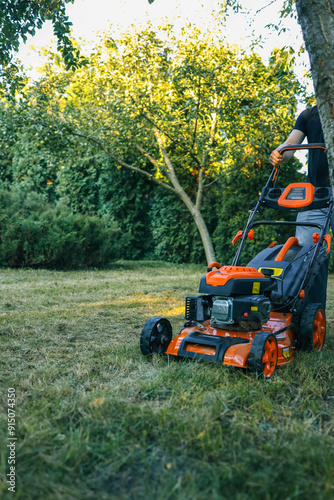 The gardener is tending the garden, the lawn mower is cutting the grass