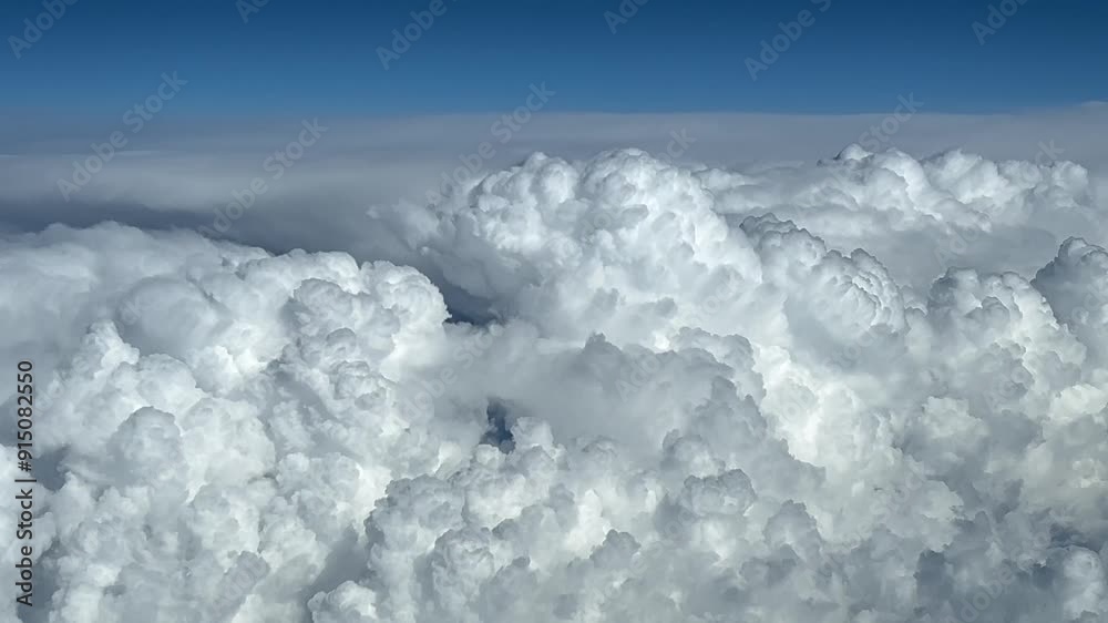 POV huge storm clouds in a blue sky seen from above. Shot from an airplane cockpit at cruise level FL300. 4K 60FPS POV huge storm clouds in a blue sky seen from above. Shot from an airplane cockpit at cruise level FL300. 4K 60FPS