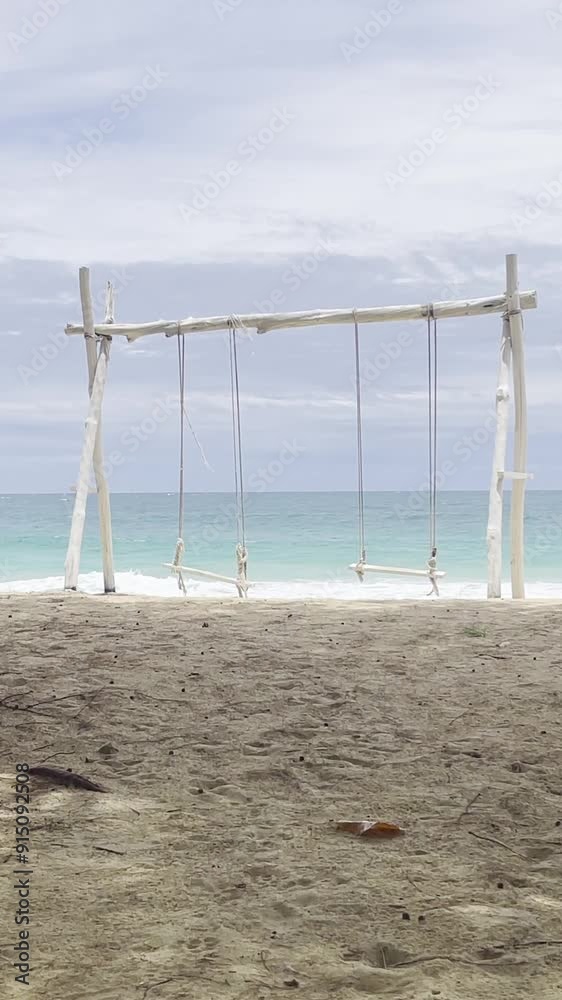 Landscapes view of beach sea sand and sky on summer day. The wave of ocean on beach. Swings near sea beach. Vacation, travel, and holiday concept. Landscapes view of beach sea sand and sky on summer day. The wave of ocean on beach. Swings near sea beach. Vacation, travel, and holiday concept.