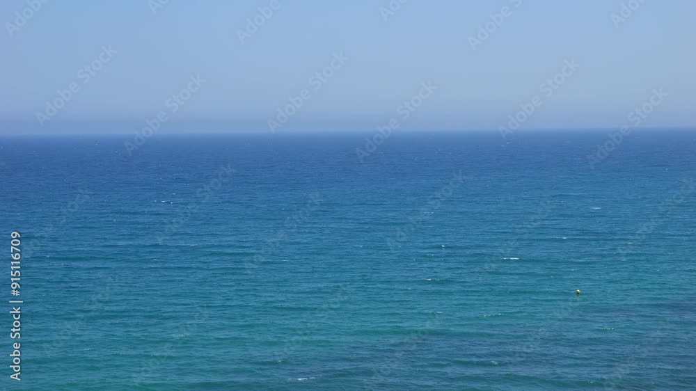 Waves on a turquoise sea, some foaming, from a human perspective. Slow-motion recording, emphasizing the serene and rhythmic movement of the ocean. Waves on a turquoise sea, some foaming, from a human perspective. Slow-motion recording, emphasizing the serene and rhythmic movement of the ocean.