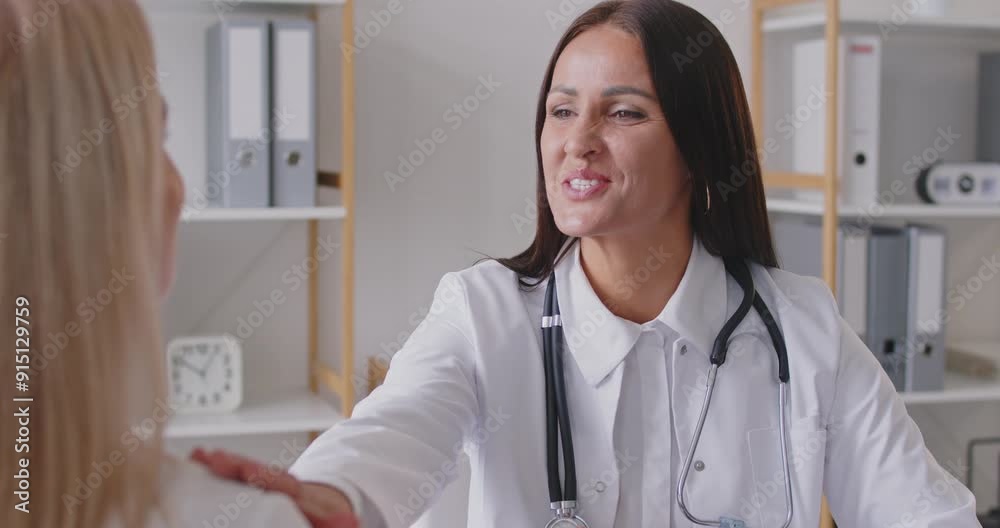 Beautiful young female doctor talking friendly to a patient, close-up. The therapist smiles and gives hope to the patient. Concept consultation with a gynecologist, pregnancy planning Beautiful young female doctor talking friendly to a patient, close-up. The therapist smiles and gives hope to the patient. Concept consultation with a gynecologist, pregnancy planning