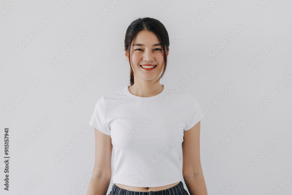 Φωτογραφία Beautiful asian Thai woman wear white, smiling and looking at camera, standing isolated over white background wall